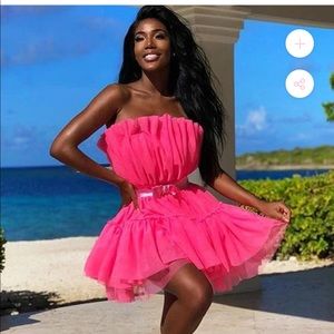 A fluffy pink dress, never worn and still have tags